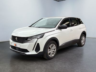 Une voiture blanche est garée dans une pièce équipée d'un ventilateur de plafond