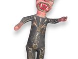 an image of a creepy looking doll made of wood