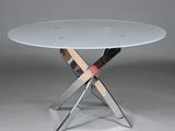 a round glass table with chrome legs and a glass top