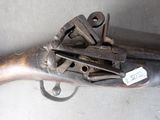 a gun that is laying on top of a table