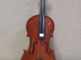 an old violin sitting on top of a table next to a wall