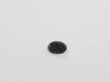 a close up of a black diamond on a white surface