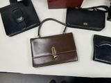 several different types of purses are lined up on a table