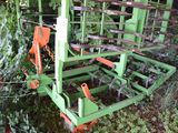 a green and orange machine that is sitting in the grass