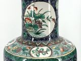 a vase with a floral design on it on a table