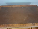 a wooden table with a brown top and a drawer underneath it