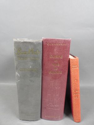 three books are stacked on top of each other on a table