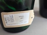 a bottle of wine with a label on it next to a bottle of wine