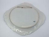 a white plate with a silver wire on top of it