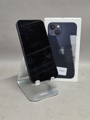 un téléphone noir posé sur un socle à côté d'une boîte blanche