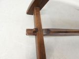 a wooden chair that is sitting on a white floor