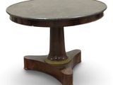 a close up of a round table with a wooden base