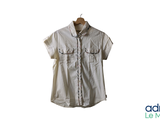 a white shirt hanging on a hanger on a white wall