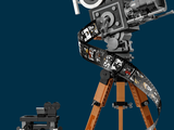 a lego movie camera on a tripod next to a toy car