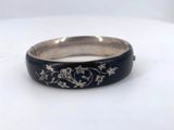 a close up of a ring with flowers on it on a table