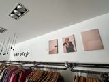 an image of a clothing store with clothes hanging on a rack