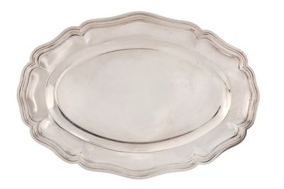 a silver plate with a scalloped edge on a white background