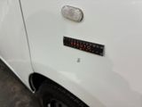 a close up of a white car with a sticker on it