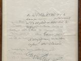 un vieux document portant des inscriptions, encadré dans un cadre en bois