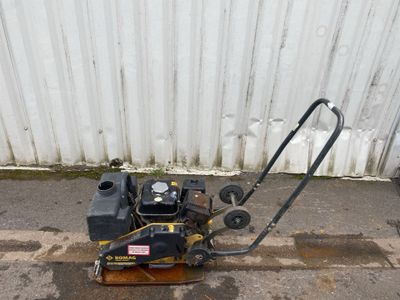 a small lawn mower sitting on the side of the road