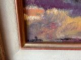an oil painting of flowers in a gold frame on a white wall