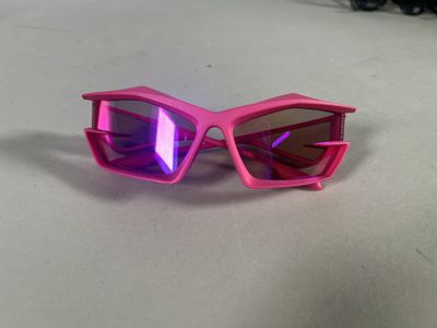 pink sunglasses with purple lenses on a white surface