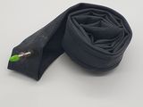 a close up of a pair of black bicycle inner tubes on a white surface