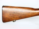 a close up of a wooden rifle on a white background