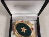 a close up of a ring in a box with a star on it