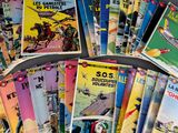 a lot of comic books on the table