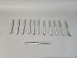 a lot of knives and a knife on the table