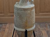 a large vase sitting on a stand on a wooden floor