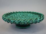 a green bowl that is sitting on a table