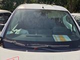 a white van parked in a parking lot next to other cars
