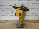 an image of a yellow and black robot on a stand