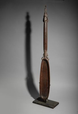 a wooden spoon with a metal handle sitting on top of a table