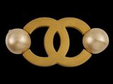 a gold and pearl broochle with two pearls