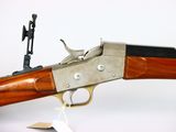 an old gun with a wooden handle on a white background