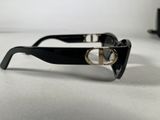 black sunglasses with a gold ring on the side of them