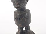 an old wooden statue of a man with a hat on his head