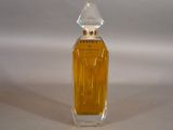 a bottle of perfume sitting on a white surface