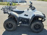 an image of a white four wheeler atv parked in a parking lot