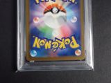 a close up of a pokemon trading card in a plastic case