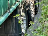 a large green truck that is parked on the side of the road