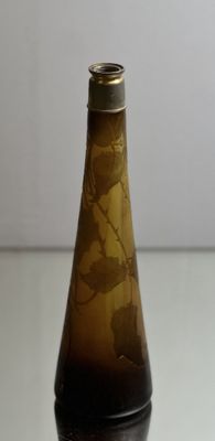 a glass bottle with a brown liquid inside of it
