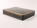 a black and gold box on a white surface