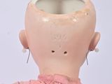 a doll with a pink dress on it ' s back