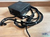 a close up of a computer power supply on a wooden table