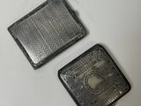 deux petits objets métalliques posés sur une surface blanche