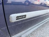 a close up of a car door handle with the word comfort written on it